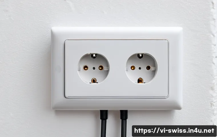 스위스의 전기 콘센트 규격 - A detailed close-up view of a Swiss Type J electrical outlet featuring three round pins with a centr...